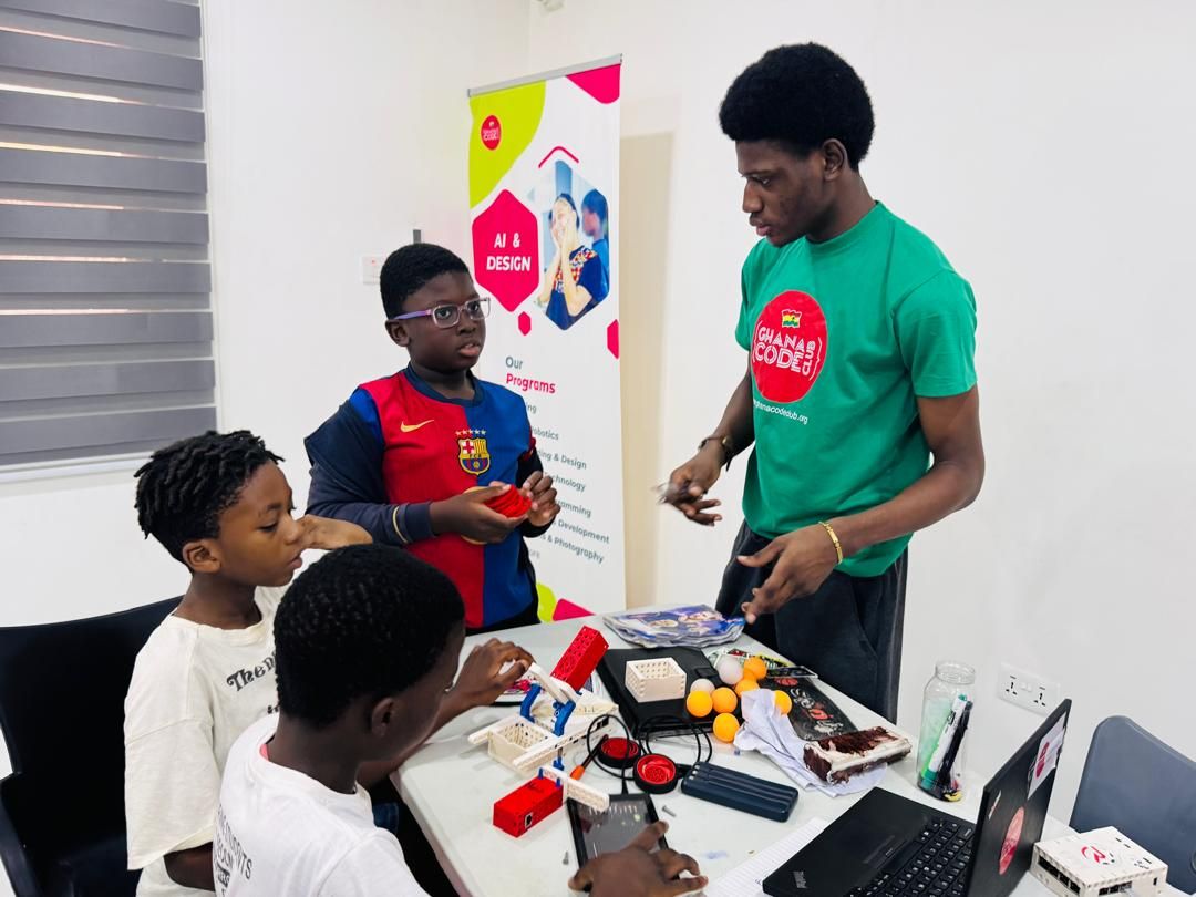 Working with Ghana Code Club students on a robotics build during a Saturday session