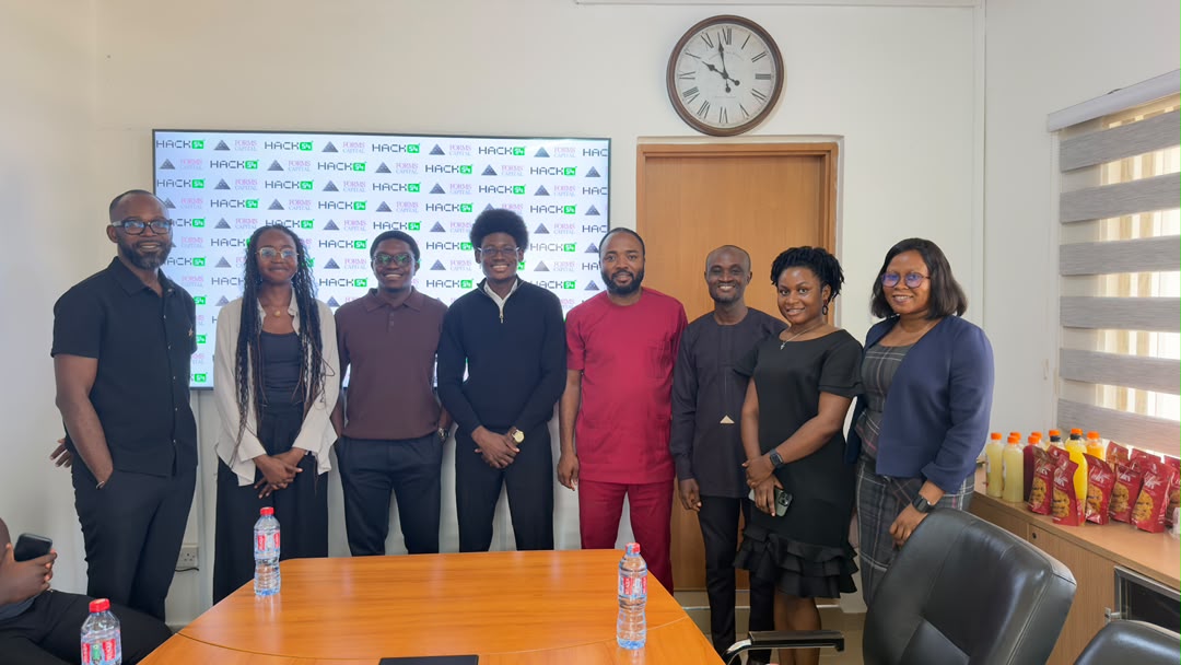 Team MobiFin with members of the Forms Capital team at their office, standing in front of a Hack54 and Forms Capital branded backdrop.