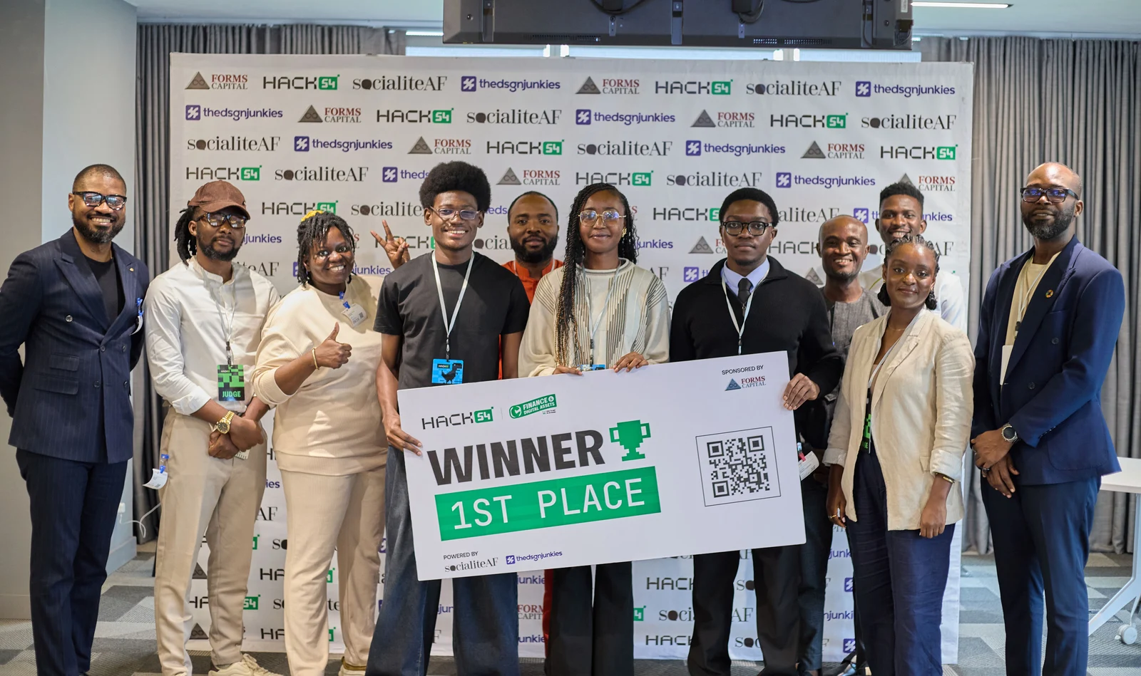 Team MobiFin holding a '1st Place Winner' sign at Hack54's Financial Hackathon, alongside judges and organizers.